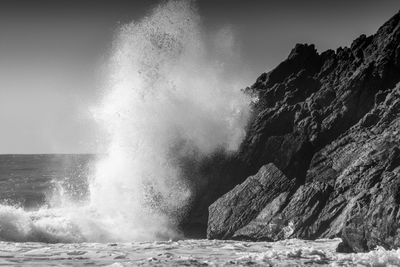 Waves splashing on rocks at shore