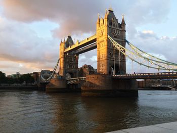 View of bridge over river against cloudy sky