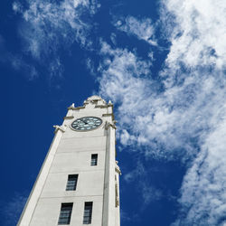 Low angle view of bell tower against blue sky