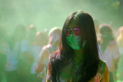 Portrait of a young woman with multi colored background