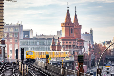 Train passing through buildings in city