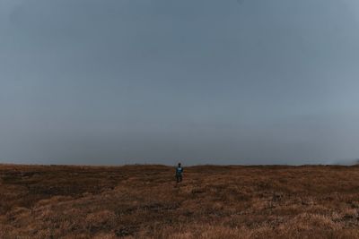 Man on field against sky