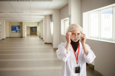 Female doctor standing in hospital lobby