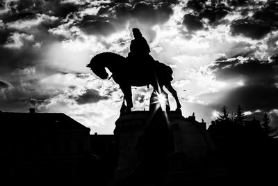 Low angle view of statue against cloudy sky