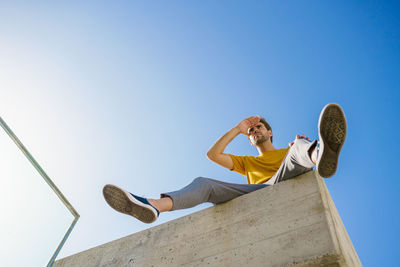 Low angle view of man against clear sky