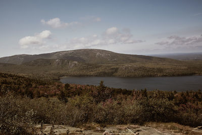 Scenic view of lake and mountains against sky