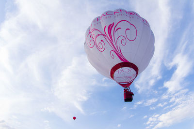 Low angle view of hot air balloon flying against sky