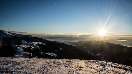 Scenic view of snowcapped mountains against sky during winter