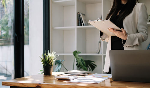 Midsection of businesswoman working in office