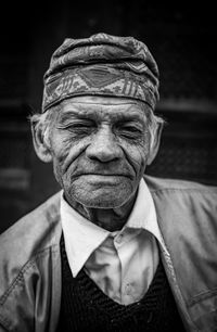 Close-up portrait of mature man wearing hat