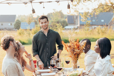 Portrait of smiling friends toasting beer glass