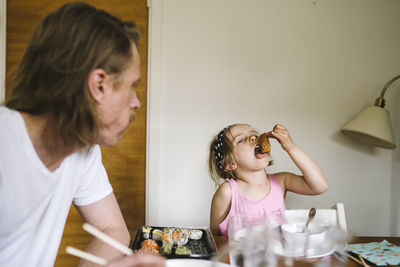 Girl eating at table