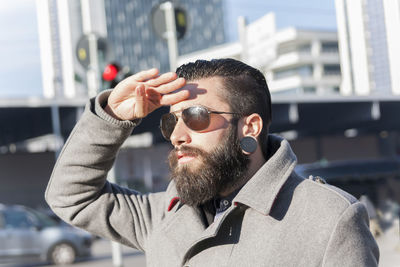 Portrait of young hipster businessman in the heart of city