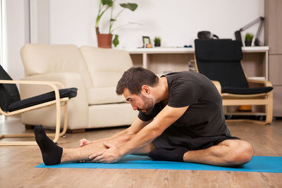 Side view of woman exercising in gym