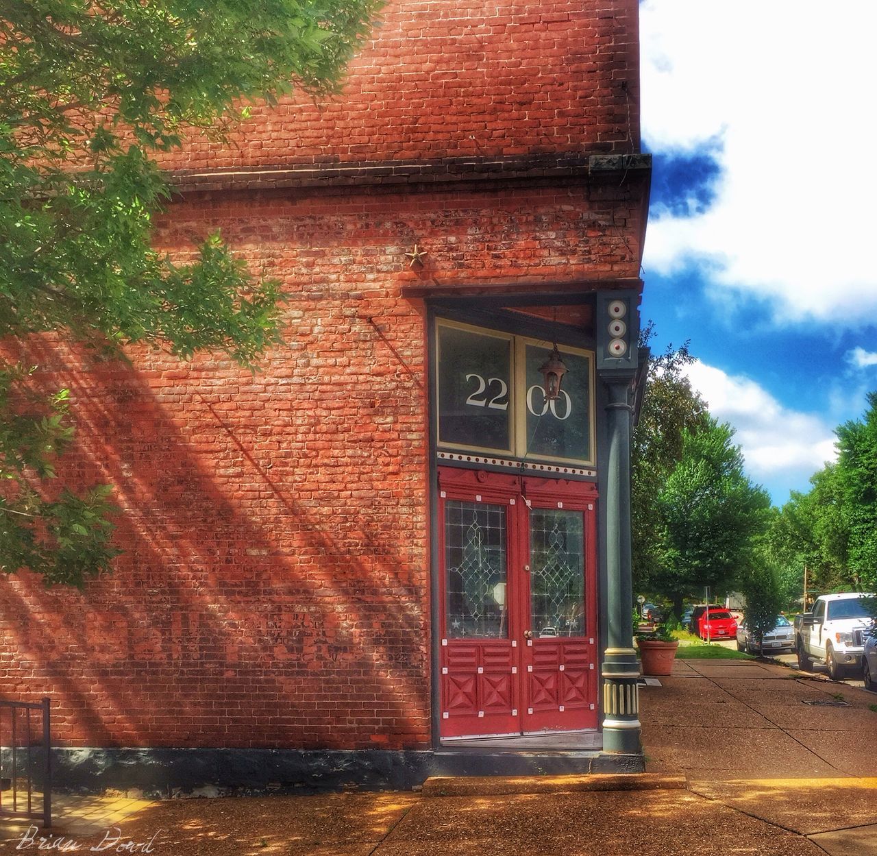 building exterior, architecture, built structure, red, tree, entrance, day, door, outdoors, closed, window, sunlight, street, facade, house, brick wall, no people, wall - building feature, sky, growth