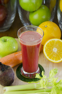 Close-up of drink amidst fruits on table