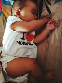 Close-up of baby sleeping on bed at home