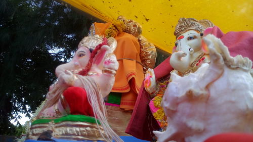 Low angle view of buddha statue against building