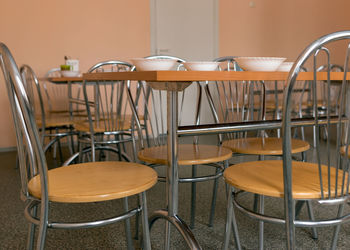 Empty chairs and tables in cafe