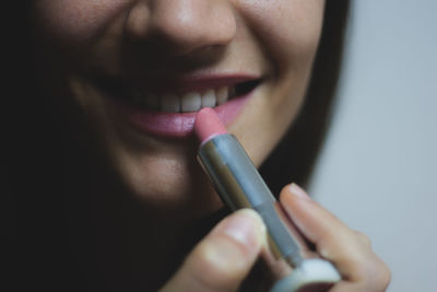 Close-up of woman applying lipstick