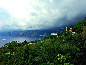 Scenic view of sea and cityscape against sky