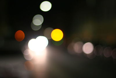 Defocused image of illuminated christmas lights at night