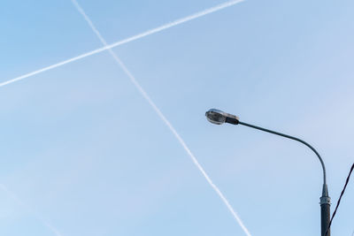 Low angle view of vapor trail against clear blue sky