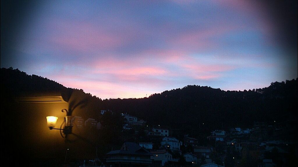 ILLUMINATED BUILDINGS AGAINST SKY DURING SUNSET