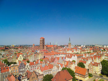 Aerial view of townscape against clear blue sky
