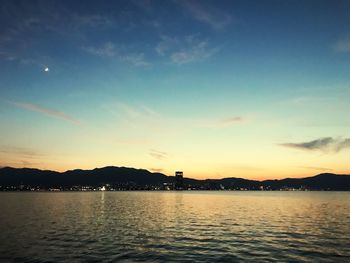 Scenic view of lake against sky during sunset