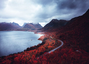 Scenic view of lake by mountains against sky