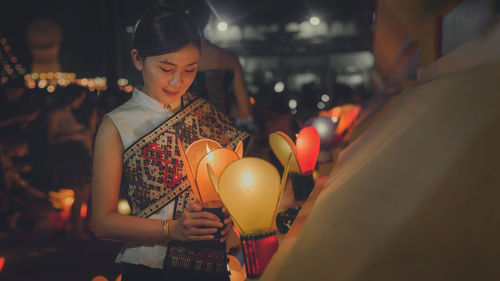 Young woman holding lantern