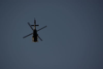 Low angle view of helicopters against clear sky