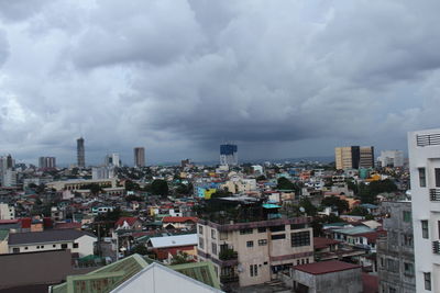 Cityscape against cloudy sky