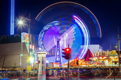 Illuminated ferris wheel at night