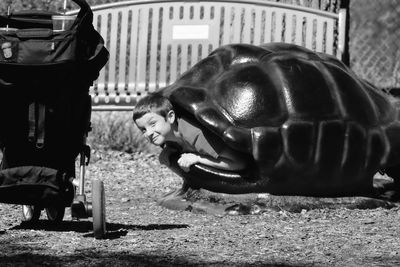 Portrait of boy in turtle shell in playground