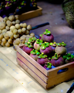 High angle view of fruits in container on table at market