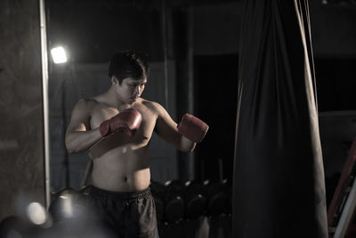 Shirtless man boxing in ring