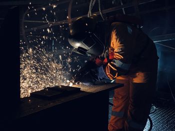 Man working on metal grate