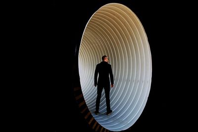 Silhouette of woman standing against black background