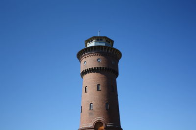 Low angle view of lighthouse against clear blue sky