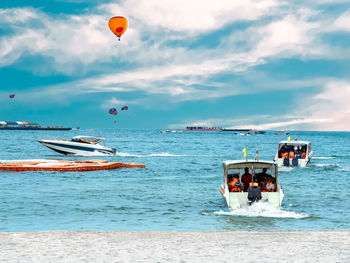 Boats in sea against sky