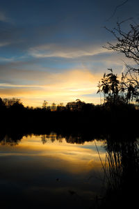 Scenic view of lake against orange sky