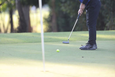 Low section of man playing golf