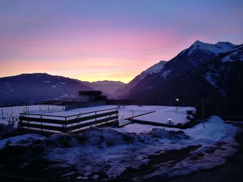 Scenic view of snow mountains against sky during sunset