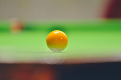 Close-up of pool ball on table