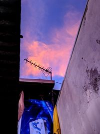 Low angle view of building against sky at sunset