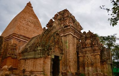 Low angle view of old temple building against sky