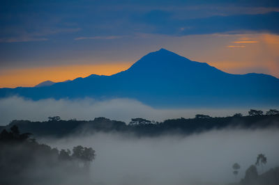 Scenic view of silhouette mountains against sky during sunset