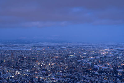 Aerial view of cityscape against sky at dusk